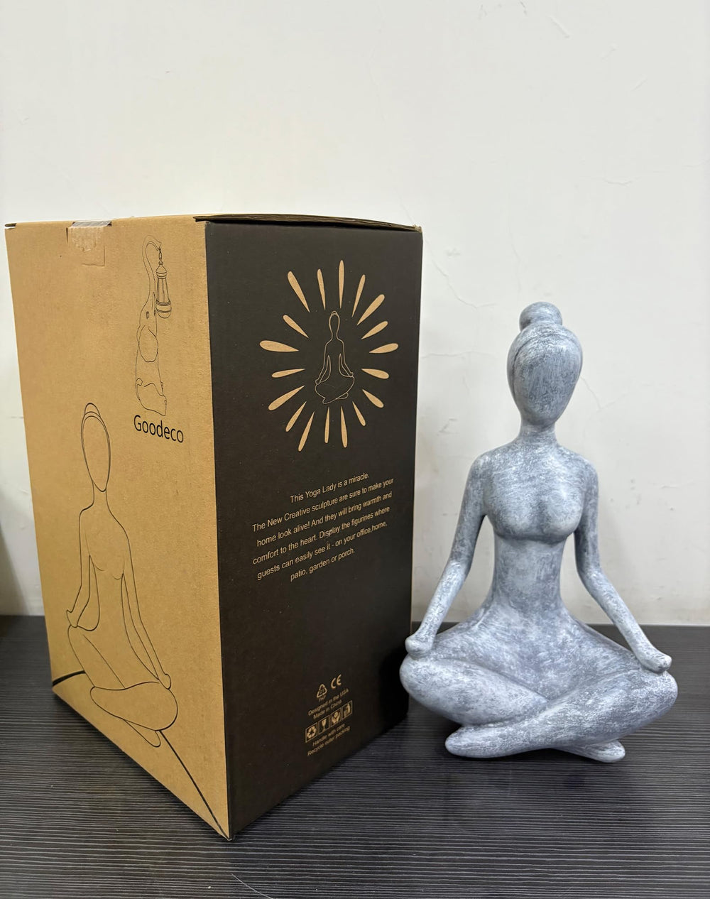 Goodeco statue placed among garden plants to create a calming focal point
