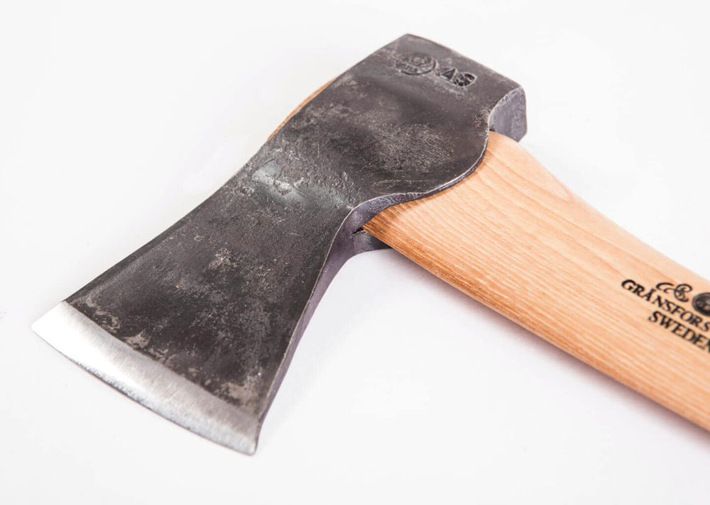 Gränsfors Bruks axe in use cutting a limb, illustrating precise control and effective felling