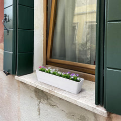 GREANER planter on kitchen windowsill with herbs demonstrating easy indoor access to fresh herbs