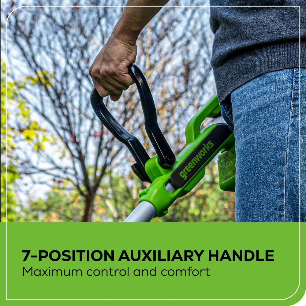 Greenworks trimmer in use cutting lawn grass showing quiet cordless operation and clean cut
