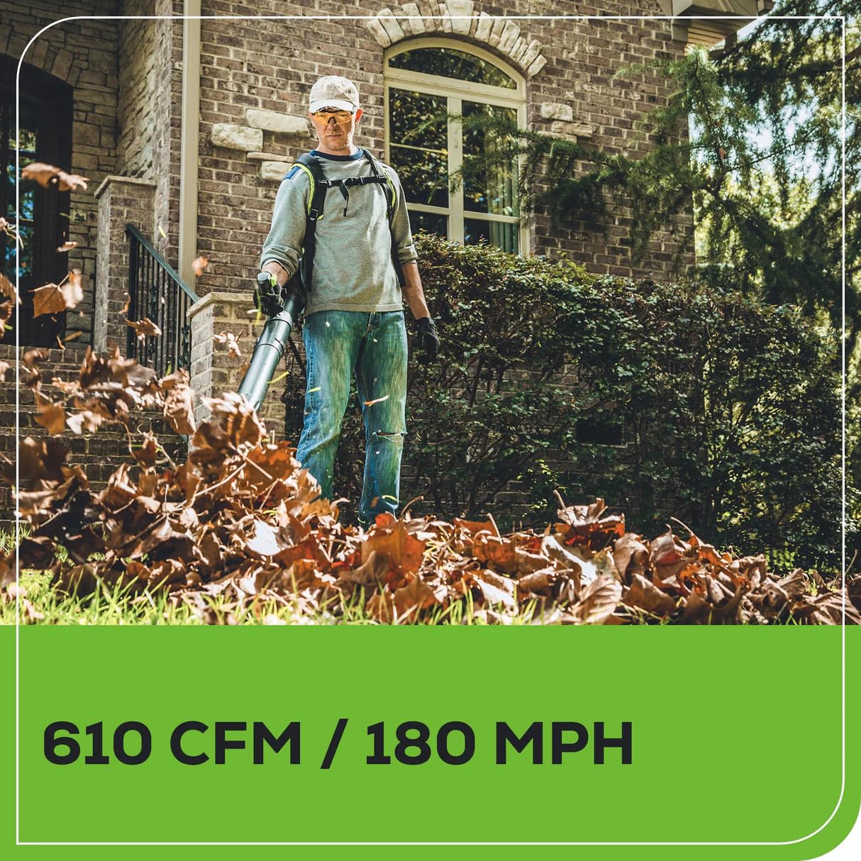 Greenworks blower in use clearing driveway showing efficient debris removal