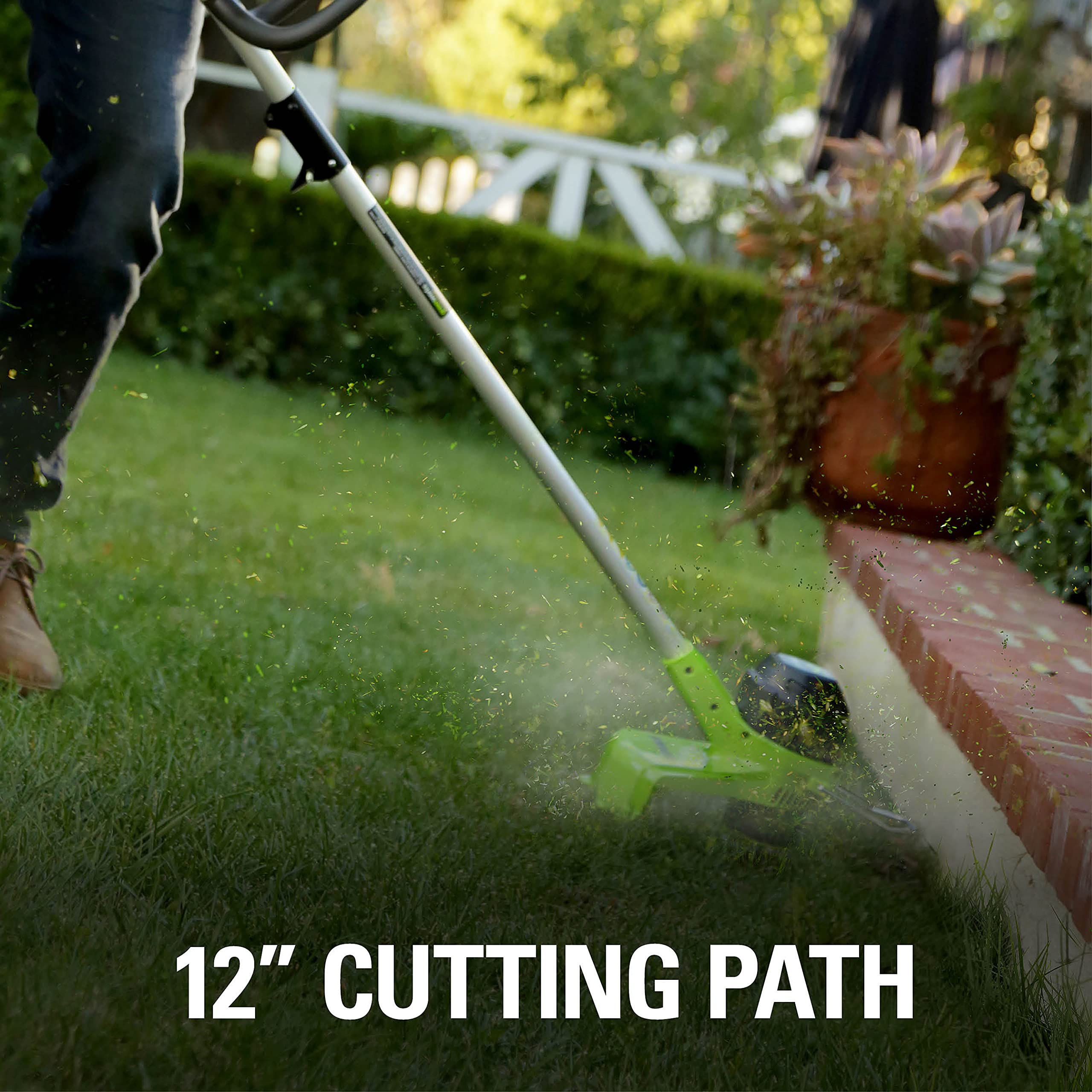 Greenworks BST4000 trimming grass along edge demonstrating precise cutting benefit