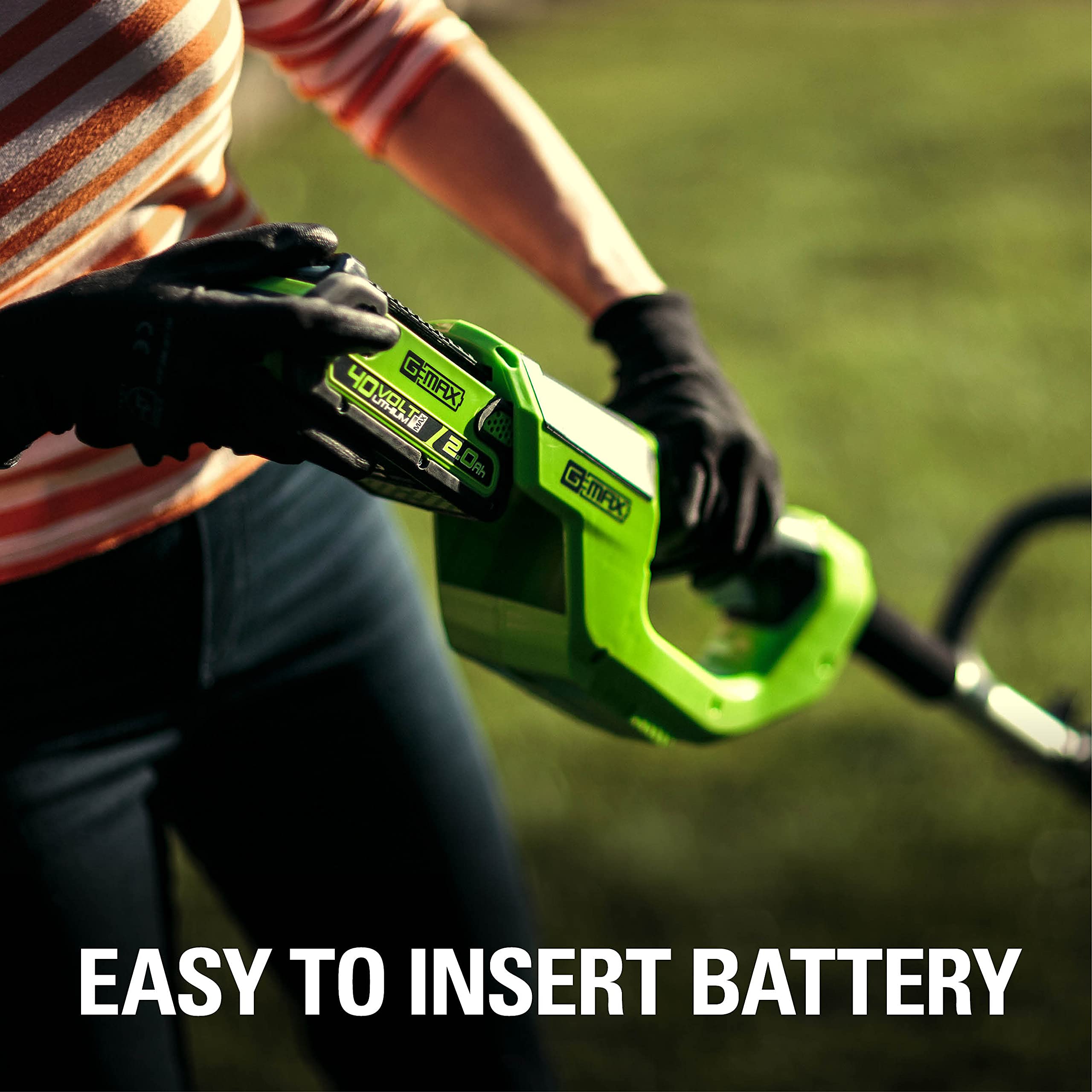 Greenworks lifestyle shot of trimmer in yard showing homeowner-friendly cordless convenience