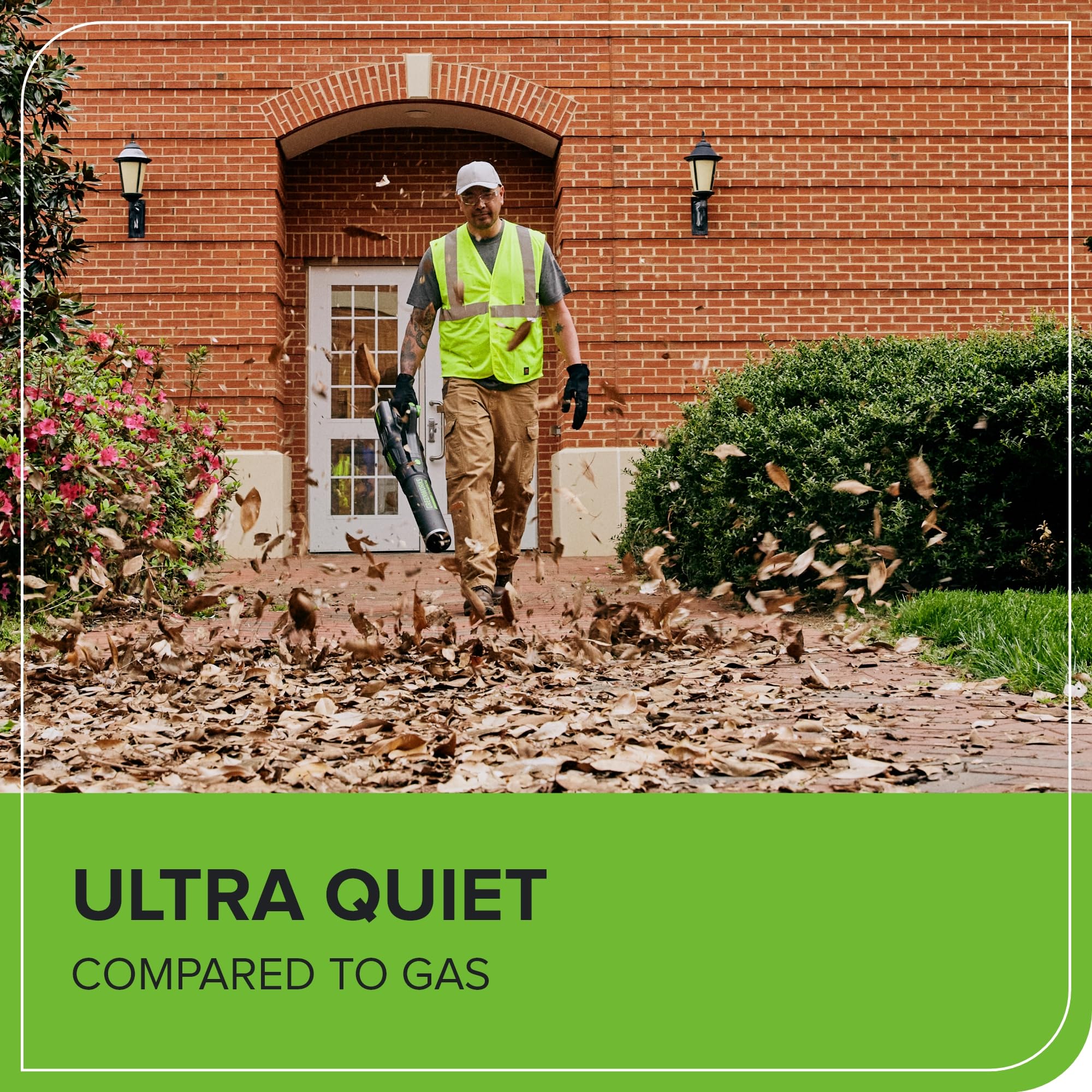 Greenworks in use clearing driveway leaves demonstrating effective large-volume debris removal
