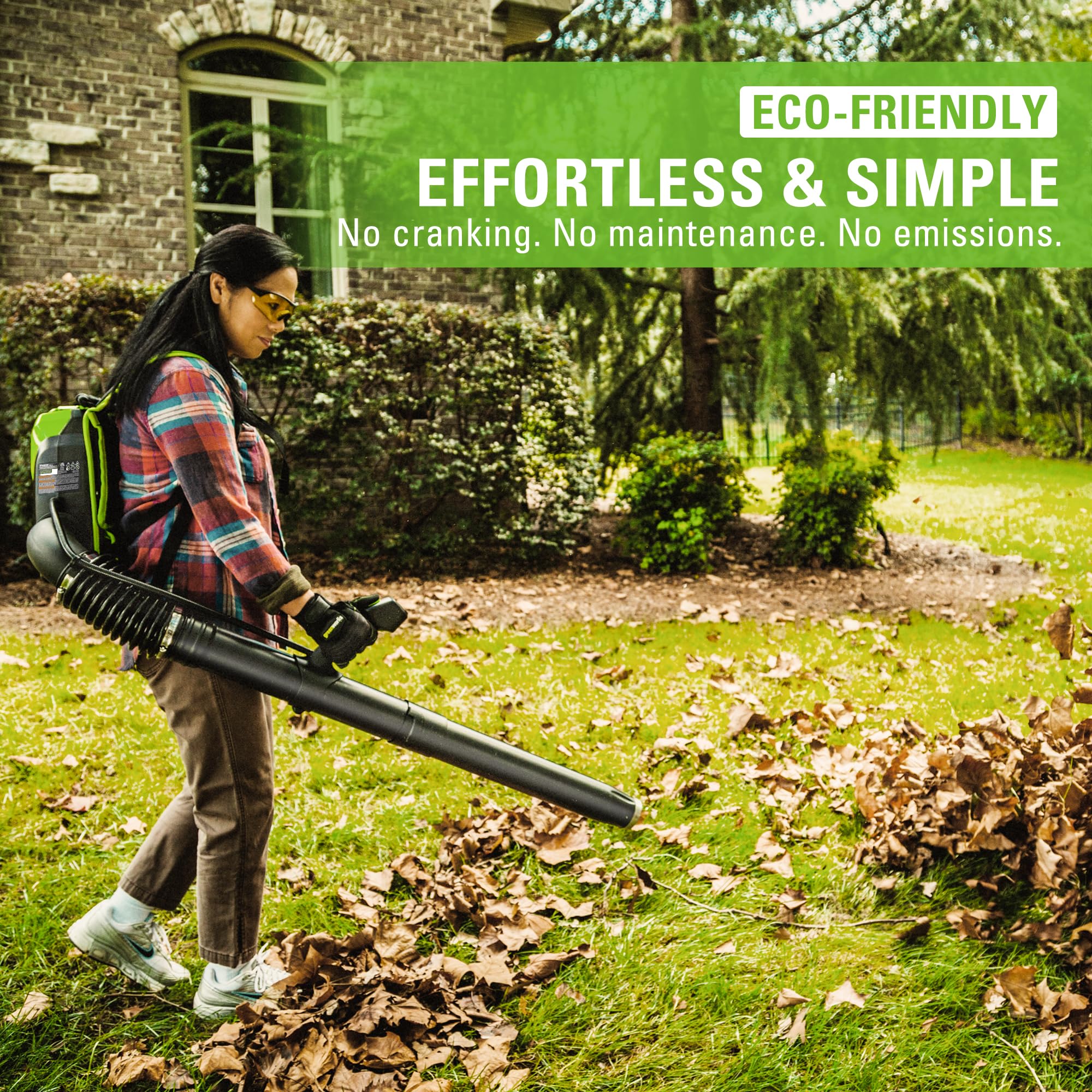 Greenworks blower in use clearing wet leaves demonstrating efficient power