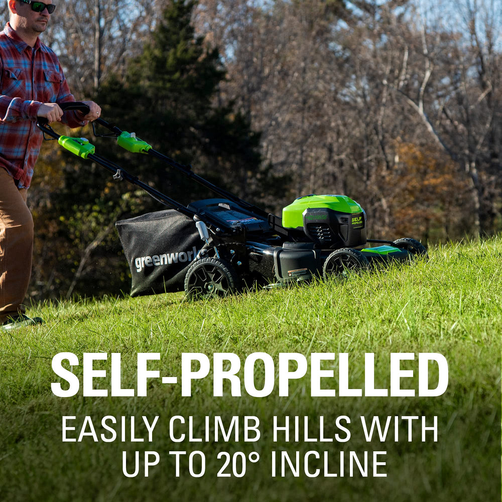 Greenworks mower next to person showing scale and maneuverability