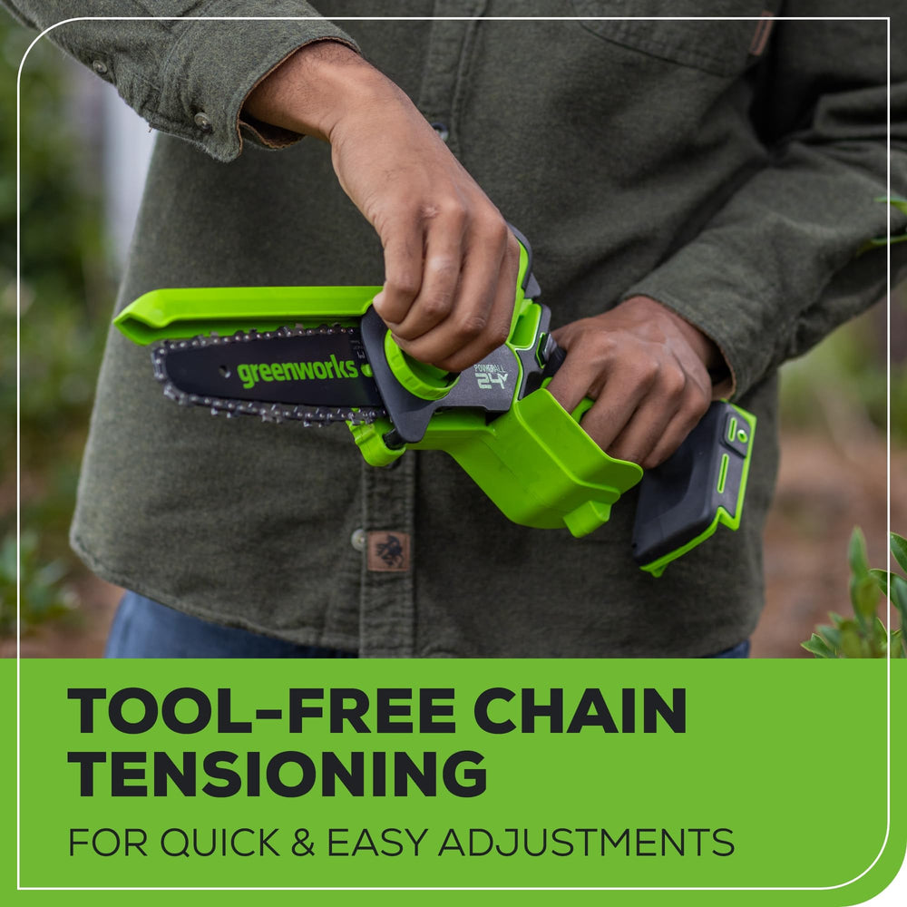 Greenworks mini chainsaw held in hand for scale and easy handling benefit