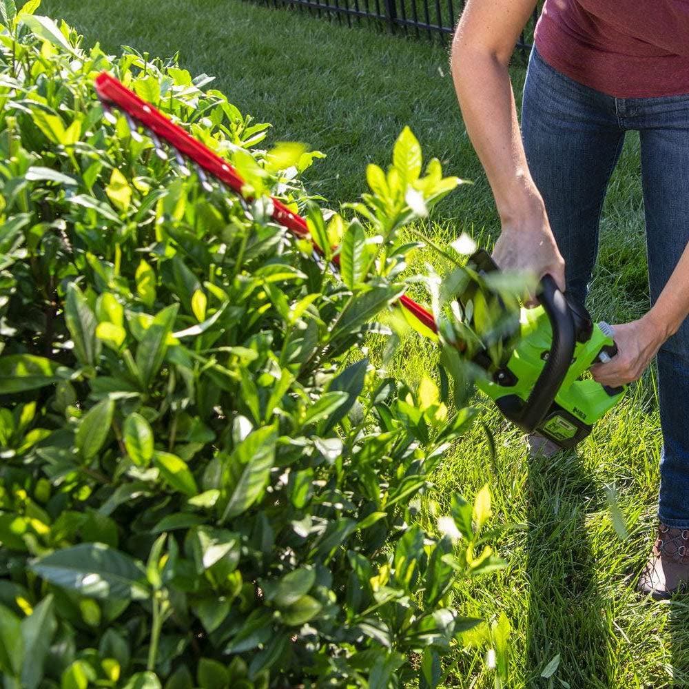 Greenworks trimmer in use shaping a hedge for faster yard maintenance