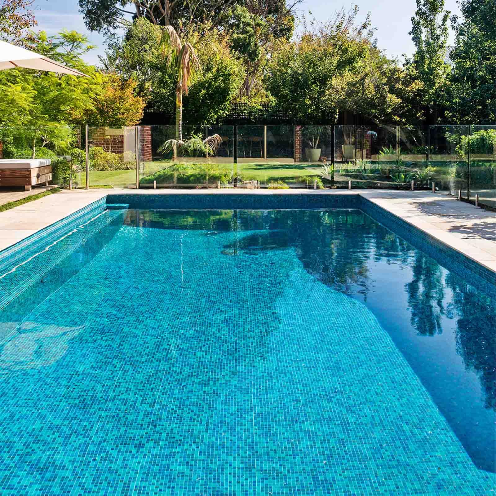 Grefilt cartridges poolside near a clear swimming pool suggesting improved water clarity