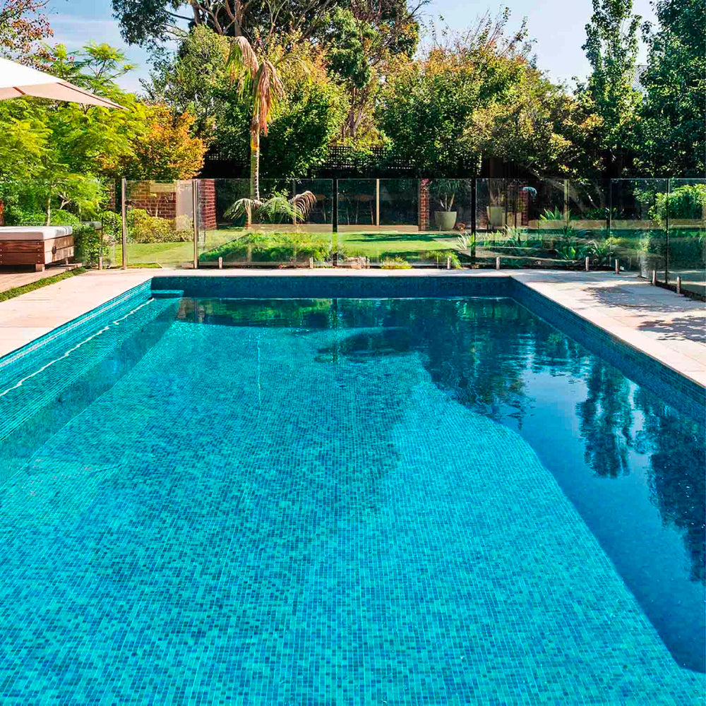 Grefilt cartridges poolside near a clear swimming pool suggesting improved water clarity