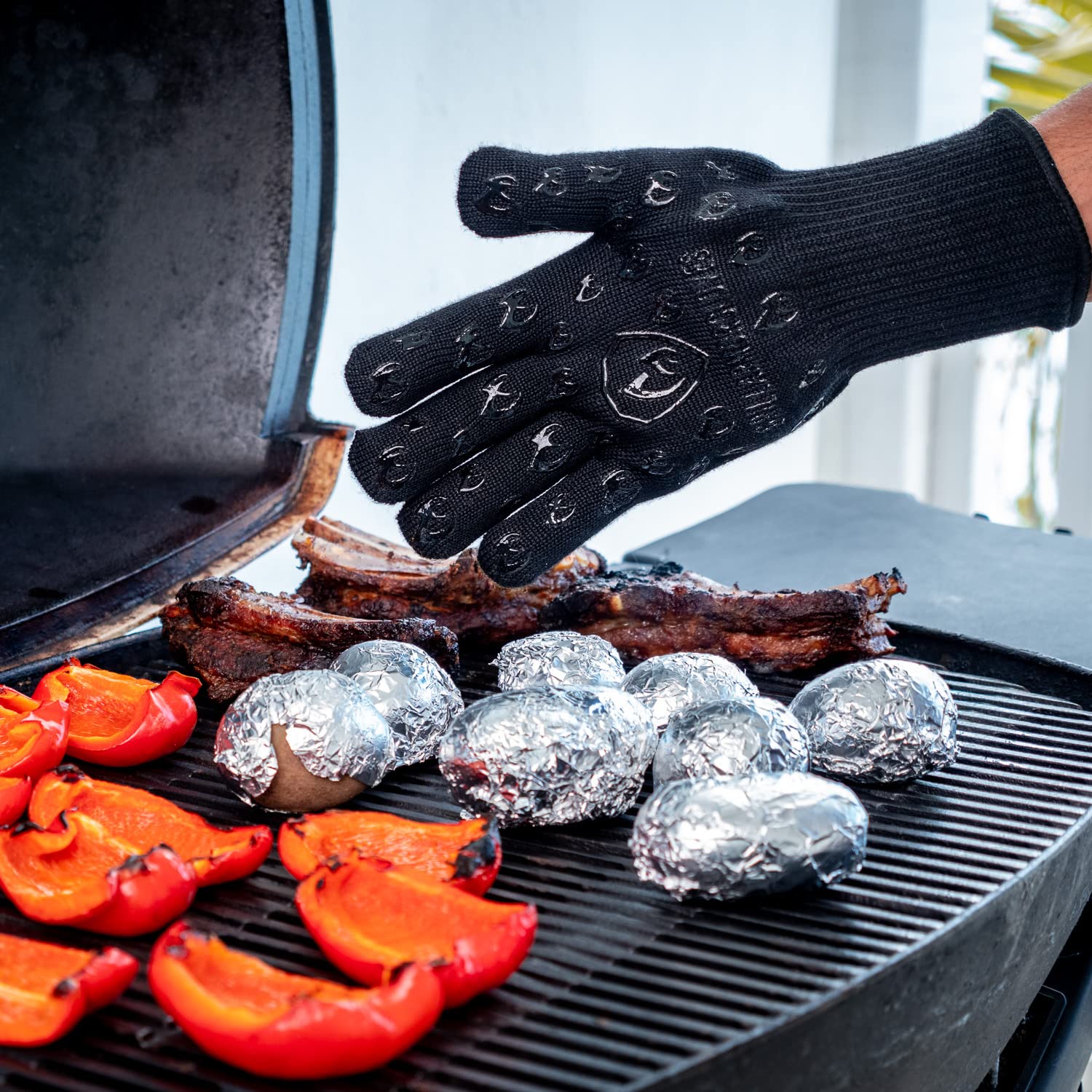 Grill Armor wearing gloves controlling tongs with fingertip precision