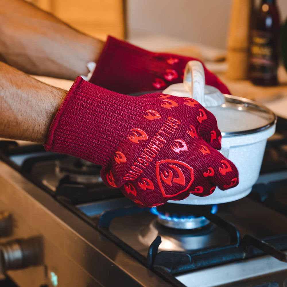 Grill Armor gloves gripping grill tongs safely near flames for confident control