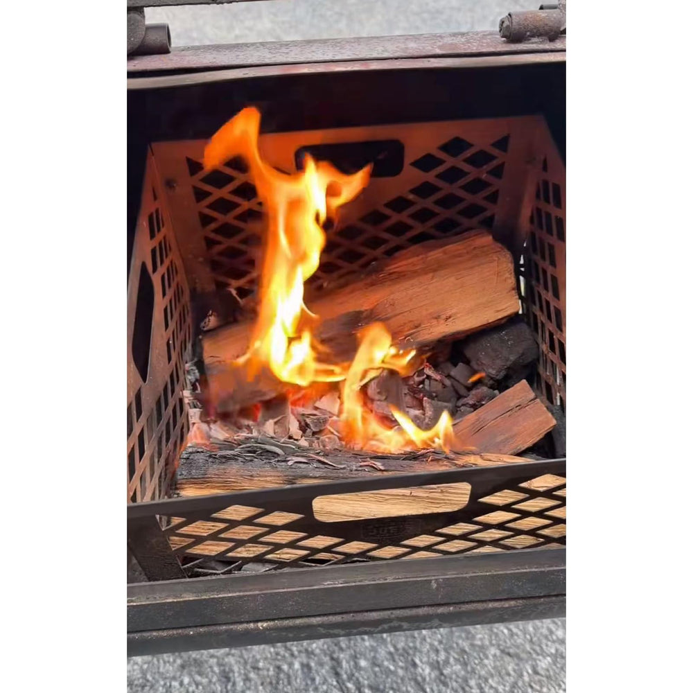 Grilltonic basket next to charcoal bag showing compact size and easy fuel capacity