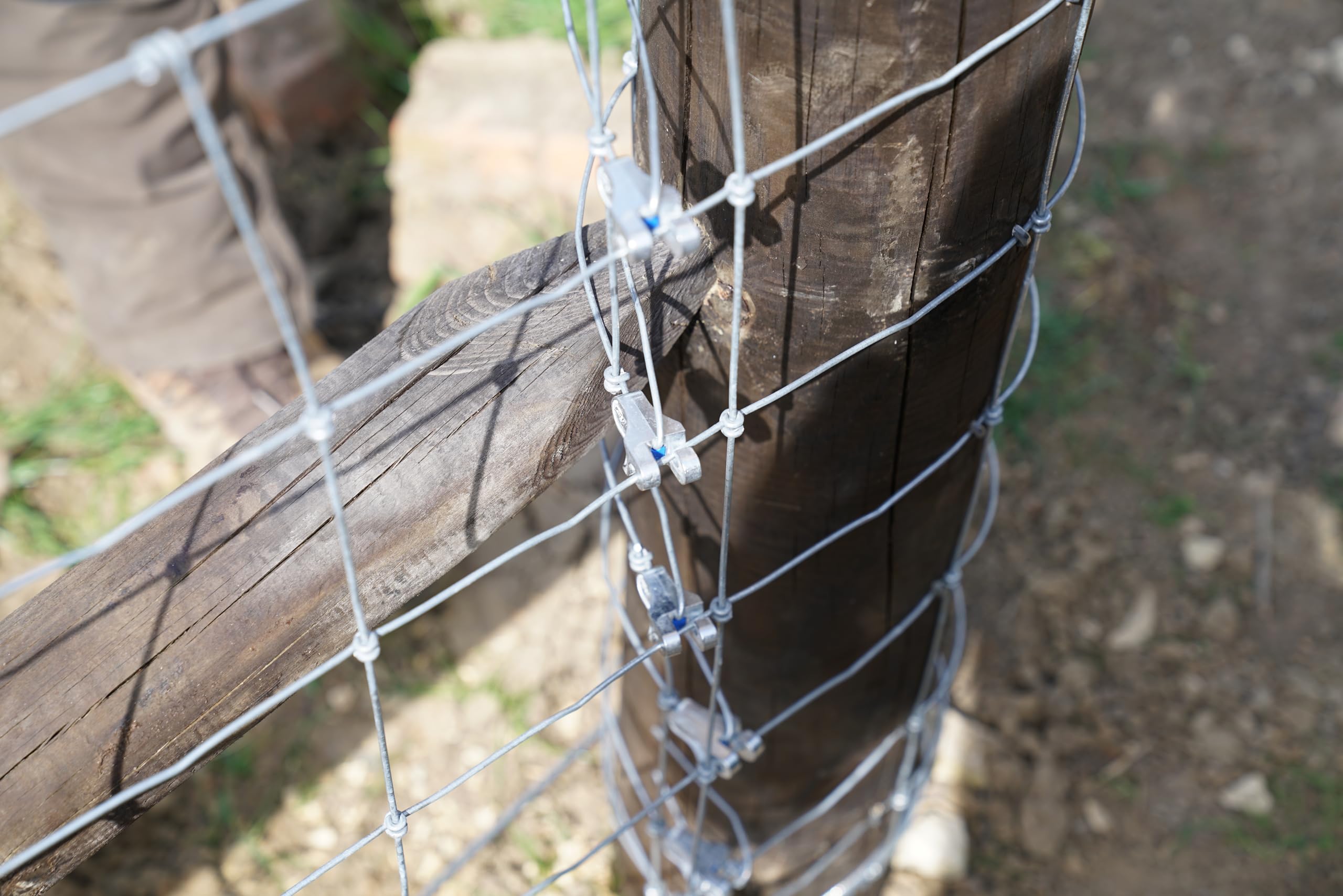 GRIPPLE T-Clip attached to a metal post showing compatibility with steel posts