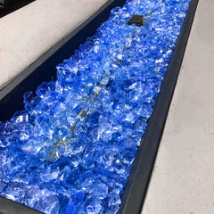 GRISUN firepit view with blue glass producing sparkling flames for ambiance