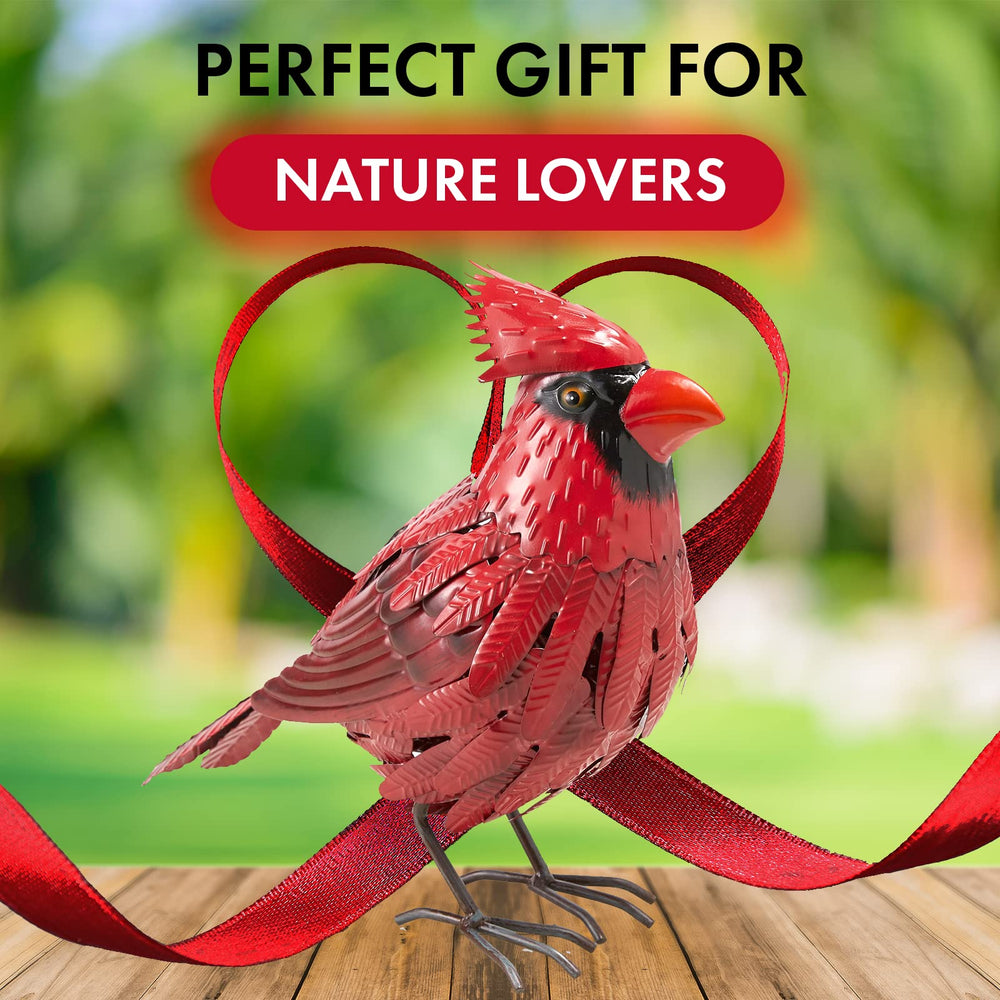 GUTE cardinal placed in flowerbed adding color and focal interest
