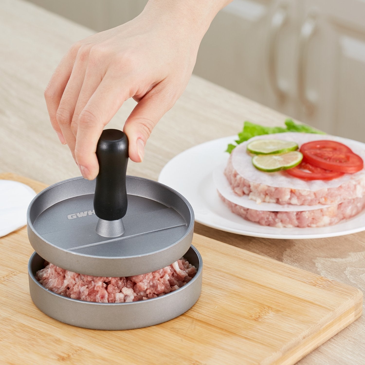 GWHOLE pressing a beef patty by hand for quick uniform burger shaping