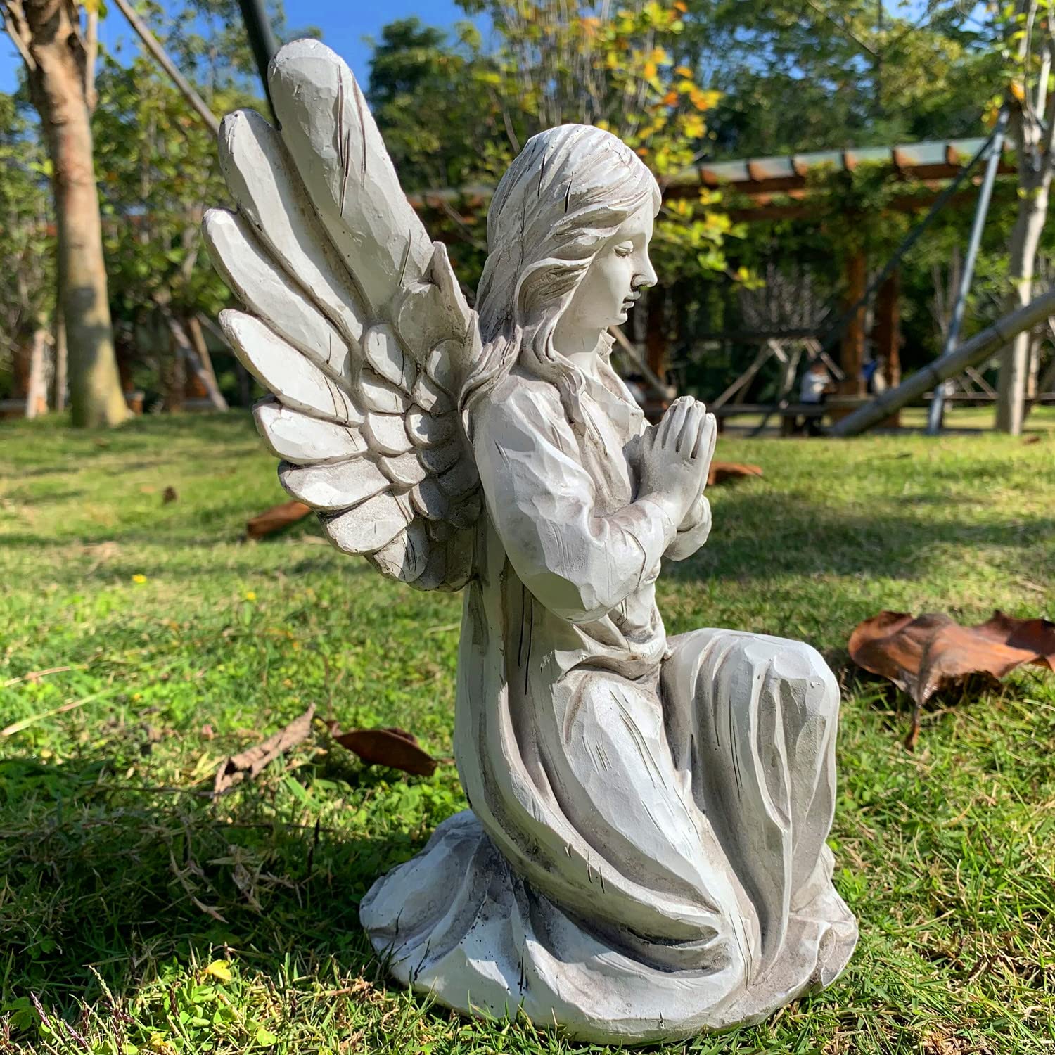 Handsider statue placed among garden plants adding peaceful focal point to yard