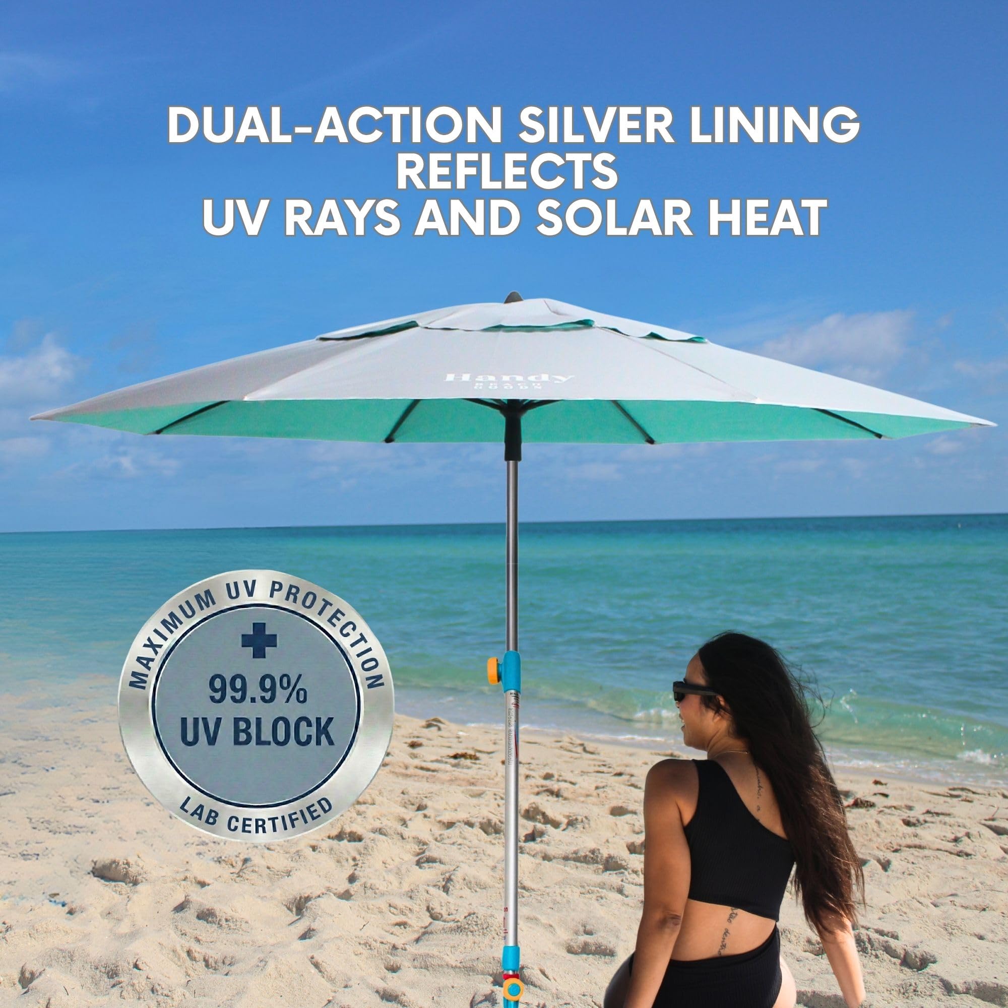 Handy Beach Goods umbrella in use on sandy beach providing stable wind-resistant shade for family