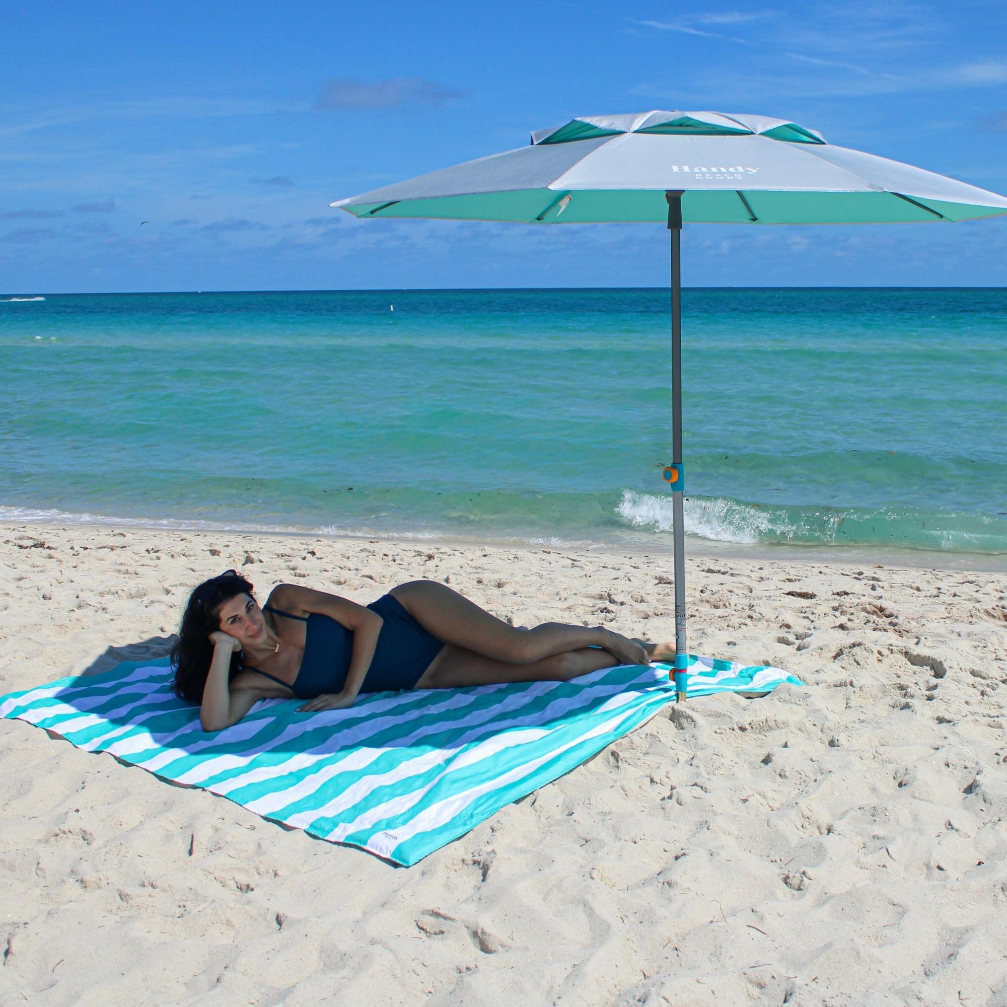 Handy Beach Goods umbrella next to beach chair showing 7ft coverage for seating and gear protection