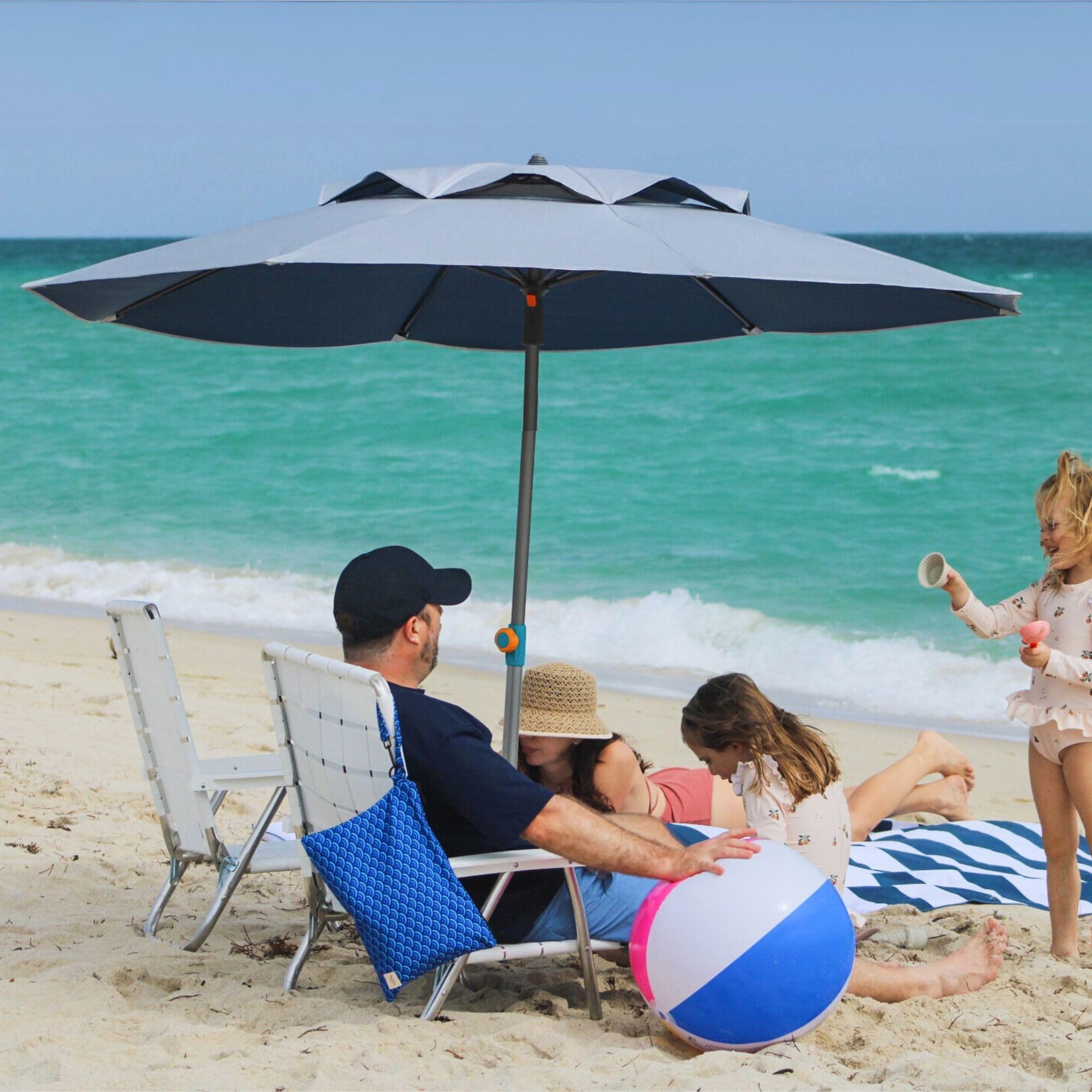 Handy Beach Goods umbrella beside beach chair showing 7ft scale and coverage