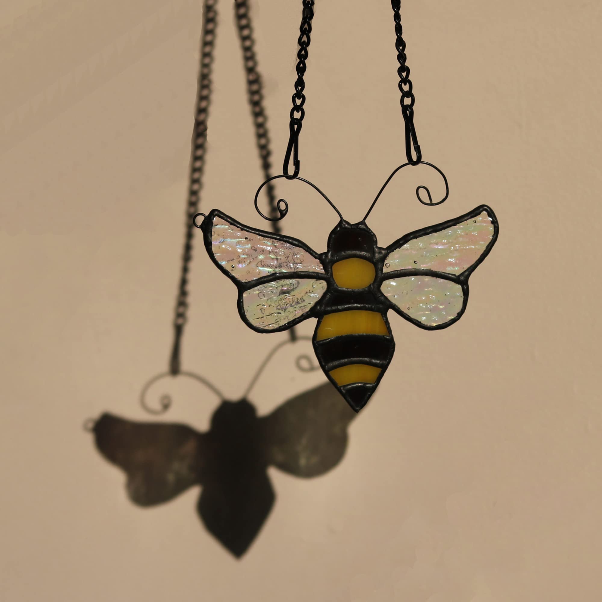 HAOSUM bee held next to a hand showing compact size and portability