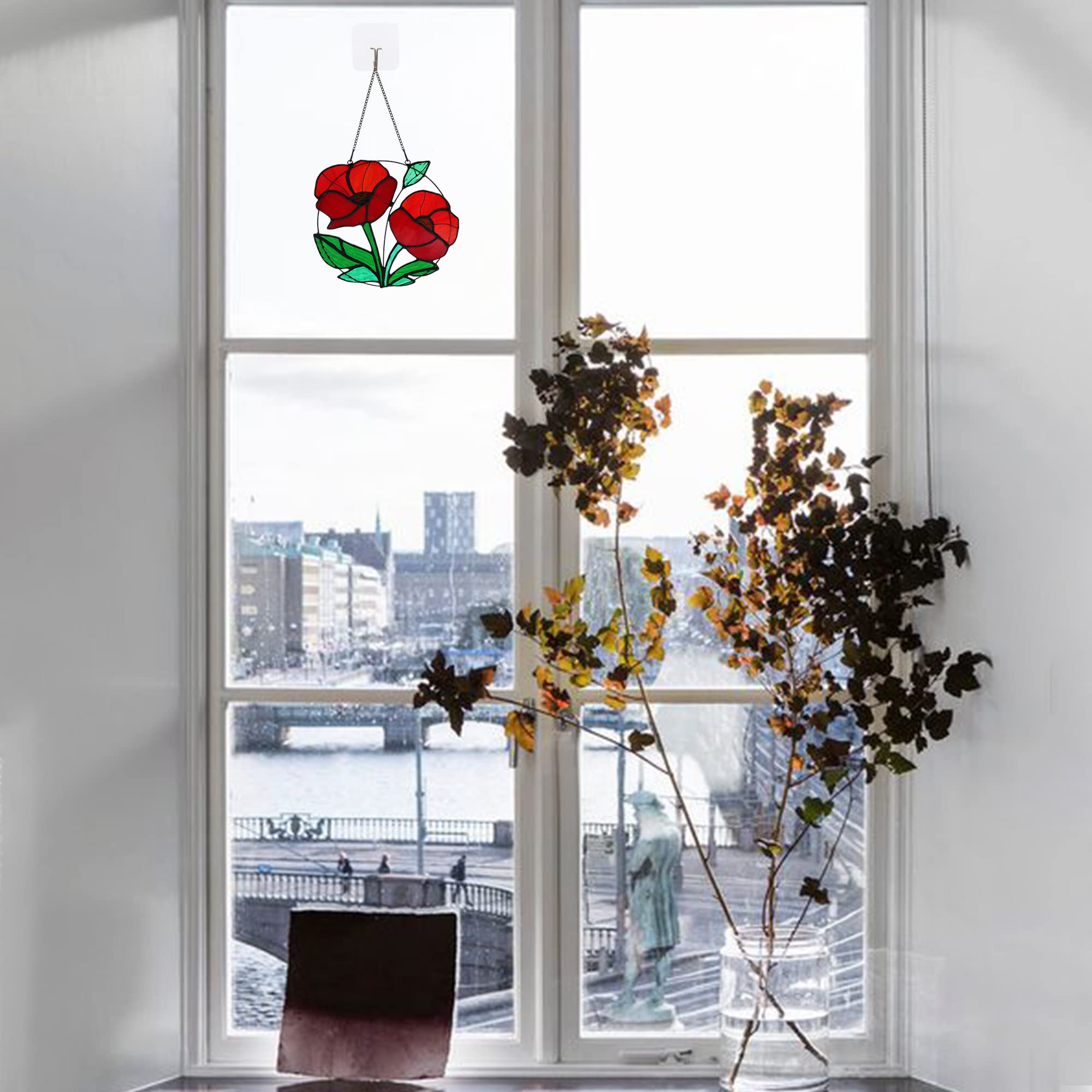HAOSUM poppy suncatcher in window casting warm red light across room