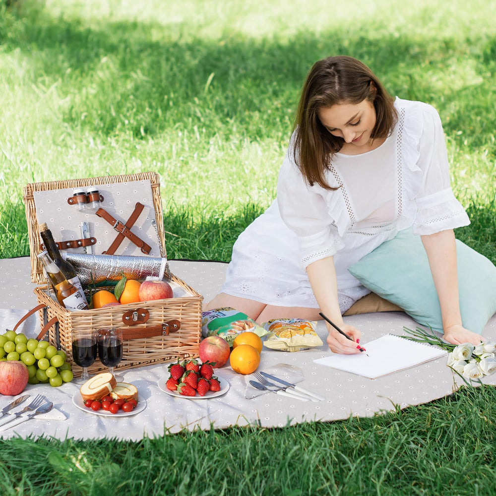 HappyPicnic basket held by hand for scale showing compact dimensions and easy carry