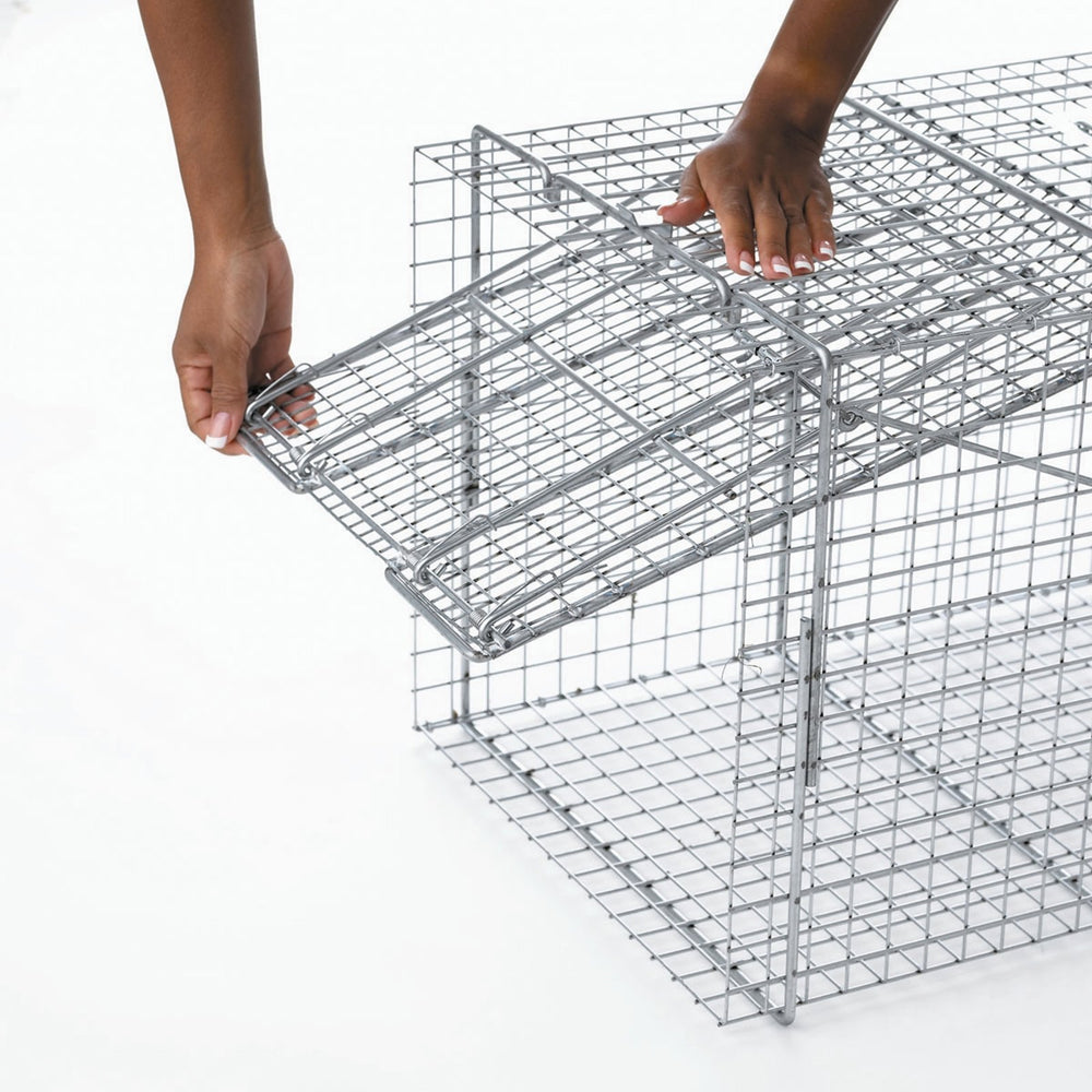 HAVAHART trap in use outdoors with handle guard for safe transport and release