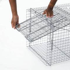 HAVAHART trap in use outdoors with handle guard for safe transport and release