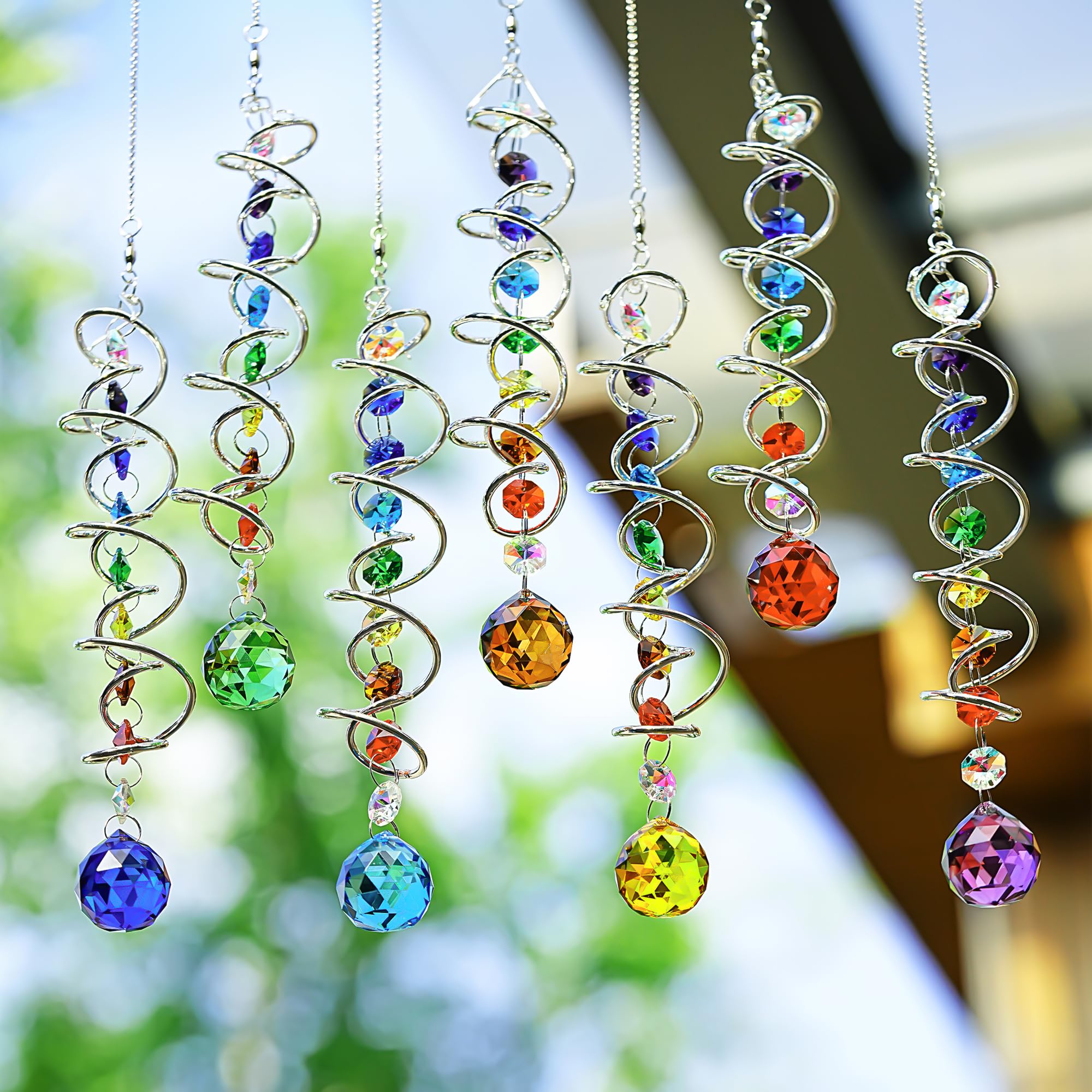 H&D HYALINE & DORA suncatcher at window casting colorful sparkles indoors