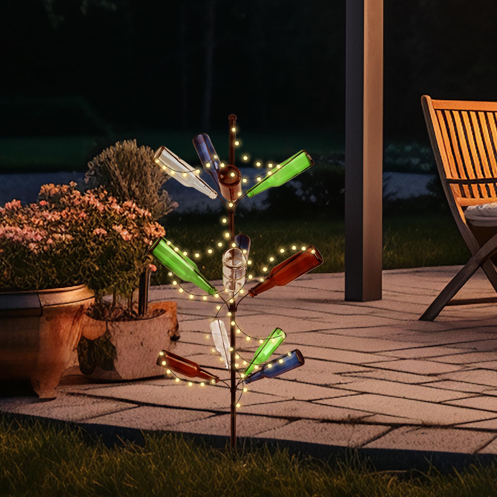 HEYTIMI bottle tree next to patio chair showing size comparison and garden placement benefit