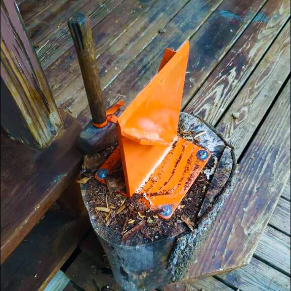 Hi Flame next to a log for scale showing compact portable size