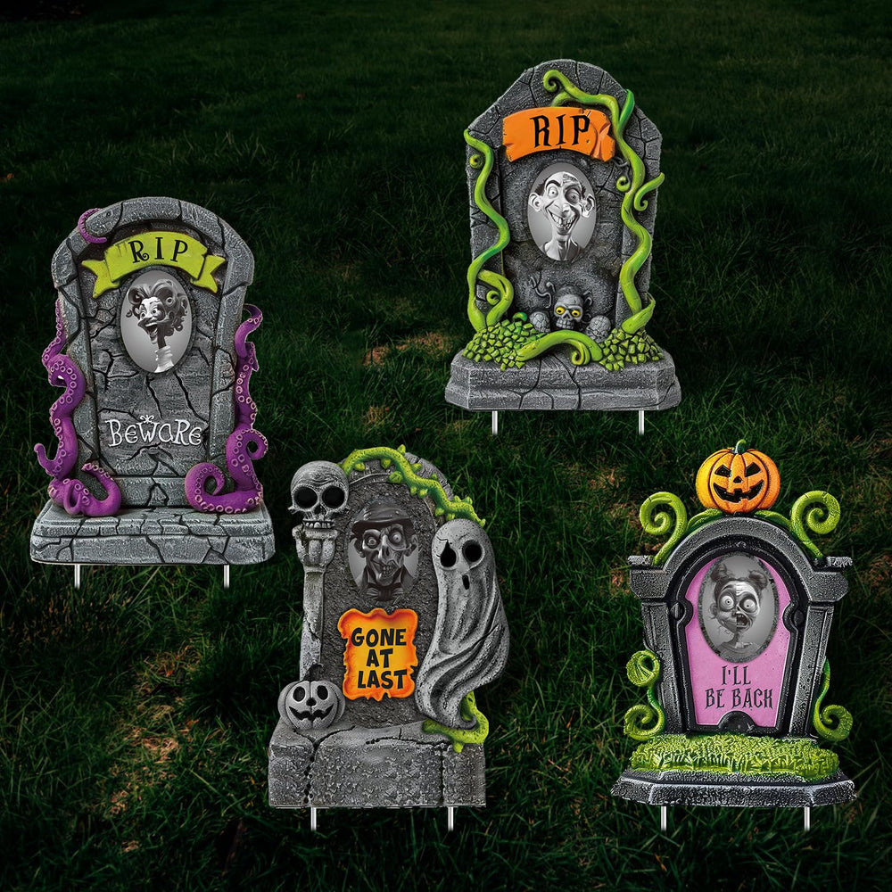 Hiboom tombstones lining a pathway with fake vines and props, creates a convincing haunted-house entrance