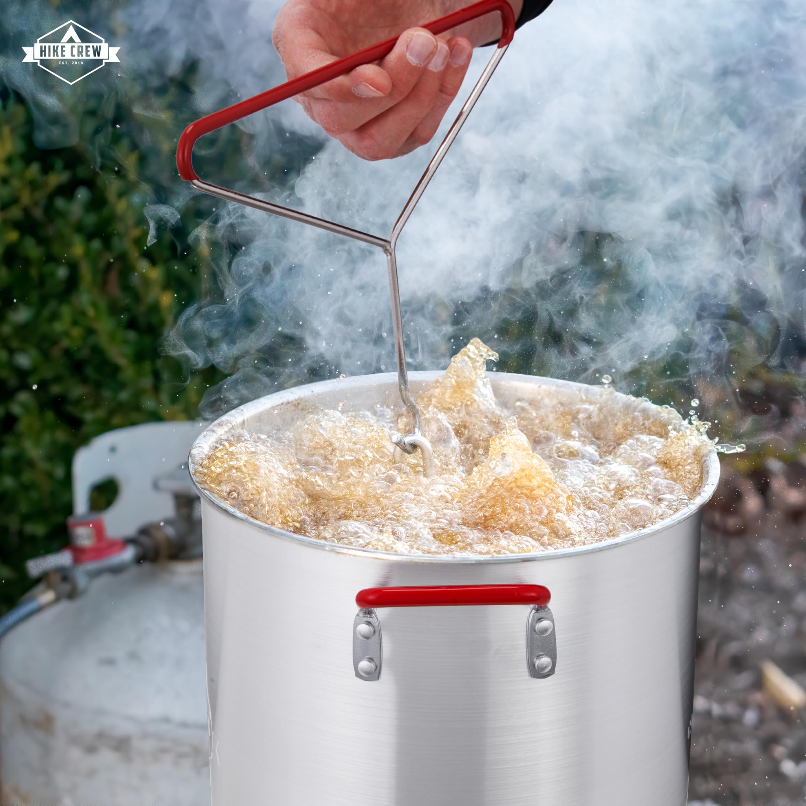 Hike Crew frying a turkey outdoors demonstrating even browning and safety
