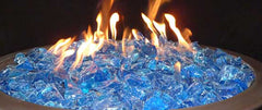 Hiland turquoise fire glass close-up in a fire pit reflecting flame light and depth