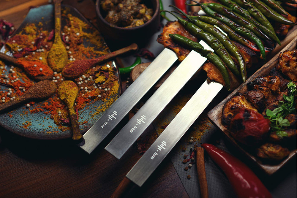 HOM skewer holding koobideh kabob over grill for even cooking control