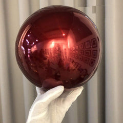 HomDSim 12 inch globe held by hand demonstrating size and portability
