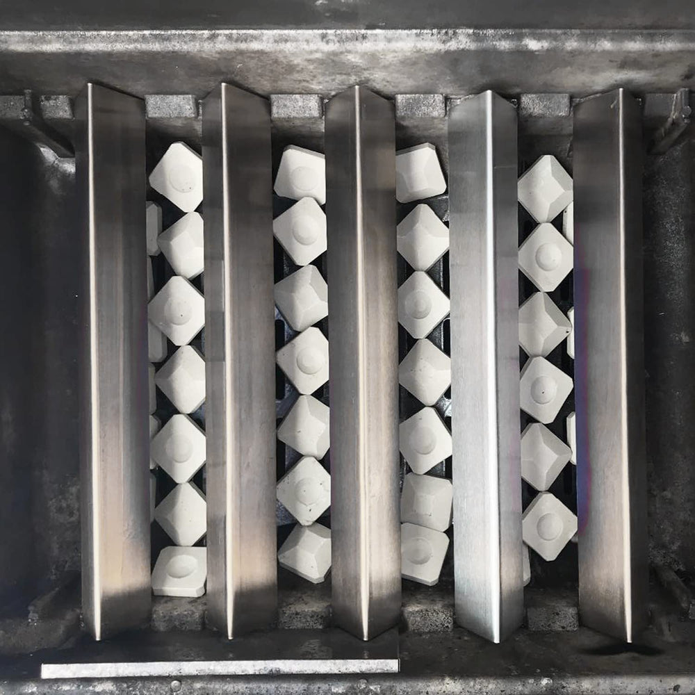 Hongso briquettes in use on an active grill demonstrating fewer flare-ups