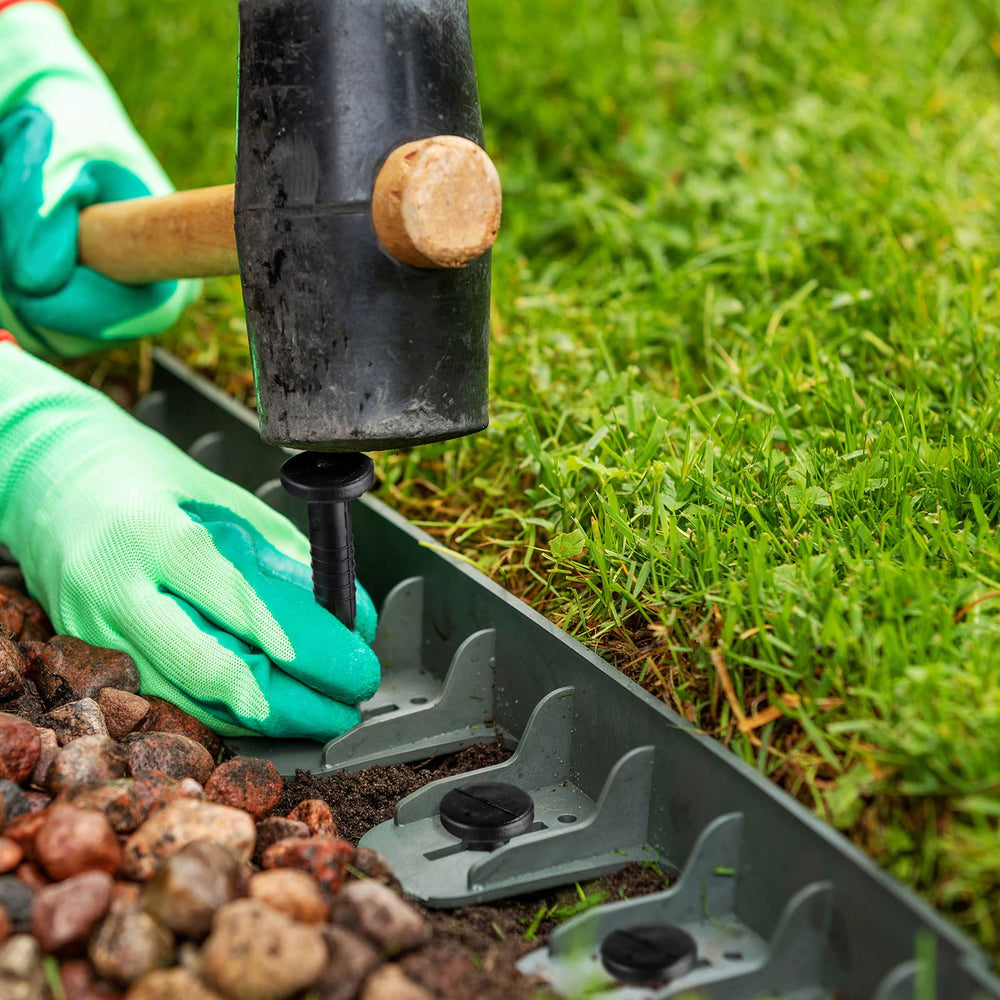 Honoson stakes holding weed fabric in place for tidy beds