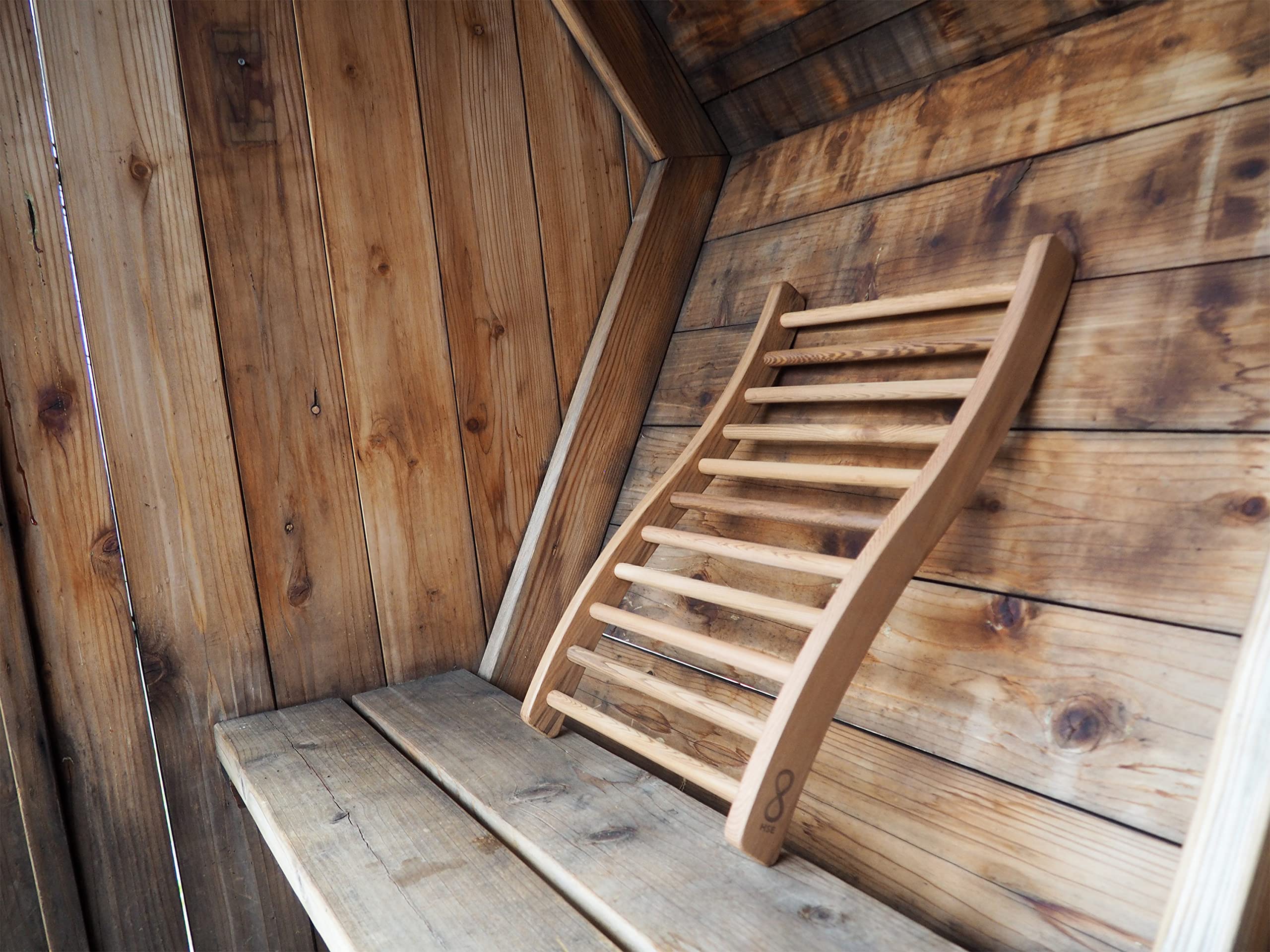 Home Sauna Experience leaning on traditional sauna bench for relaxed posture