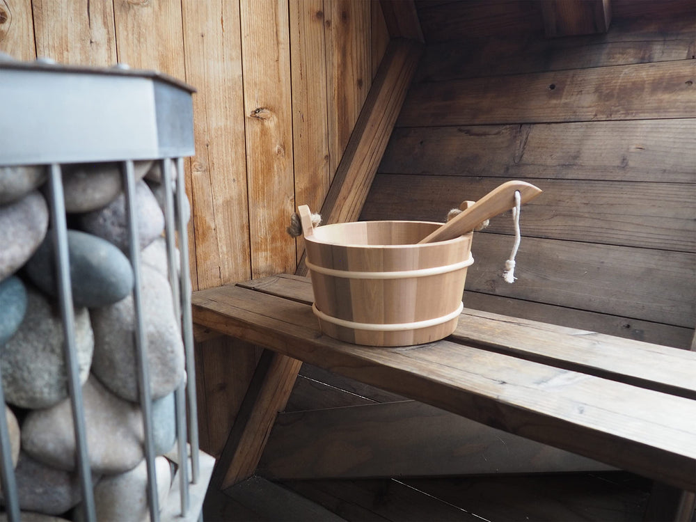 Home Sauna Experience cedar ladle close-up scoop enabling controlled steam pours