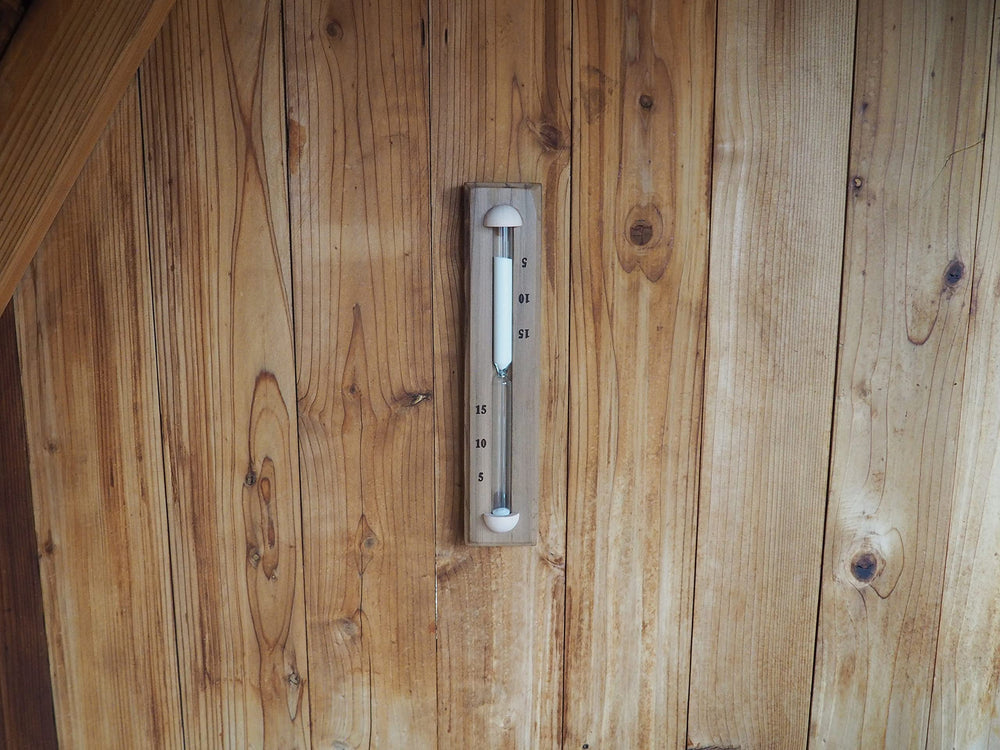 Home Sauna Experience mounted timer displaying hidden hardware and seamless wall aesthetic