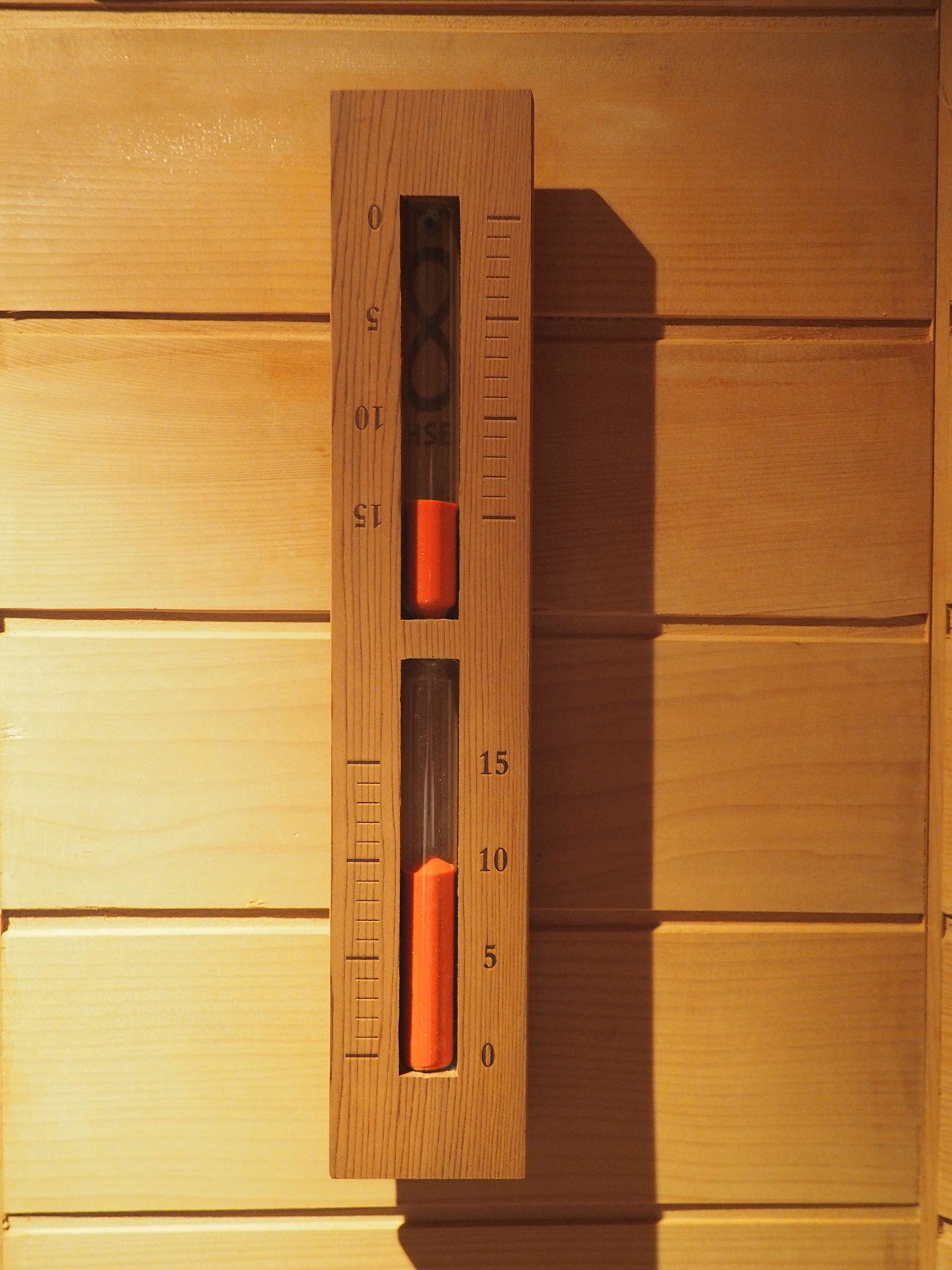 Home Sauna Experience close-up of rust red glass-bead sand showing clear 15-minute timing