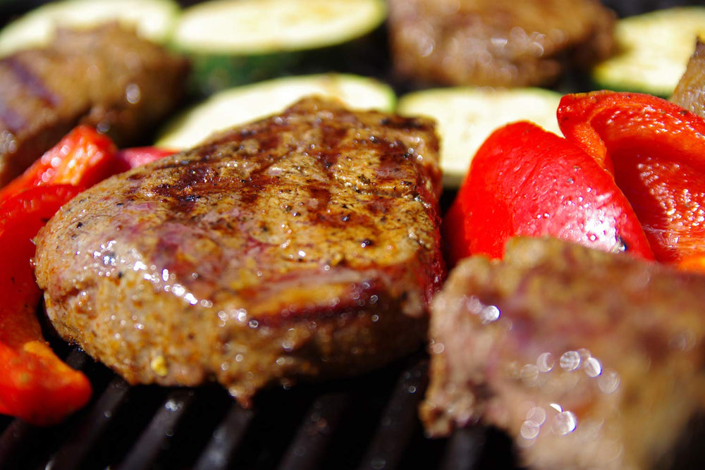 Htanch grates staged on a patio grill to show real-world cooking benefit