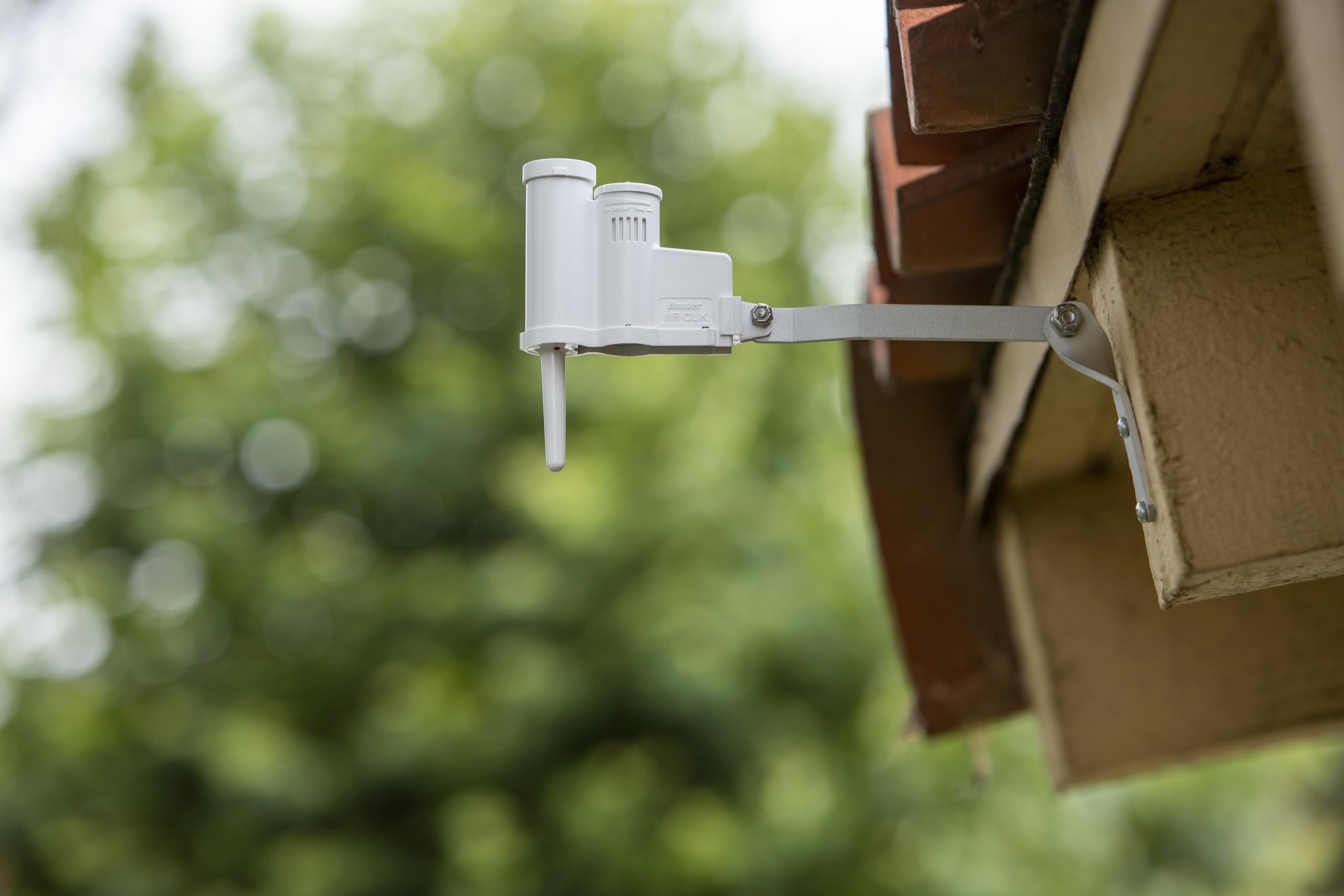 Hunter WRCLIK attached to exterior wall highlighting tool-free mounting benefit