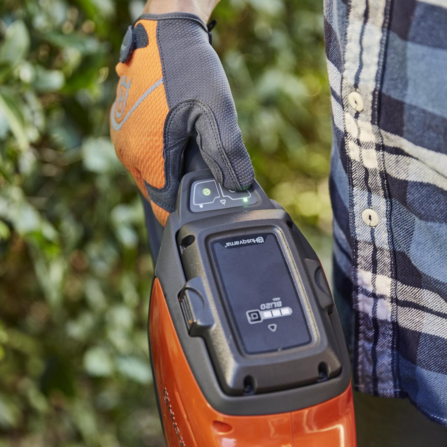 Husqvarna QC80 charger connected to battery providing fast recharge for next trimming session
