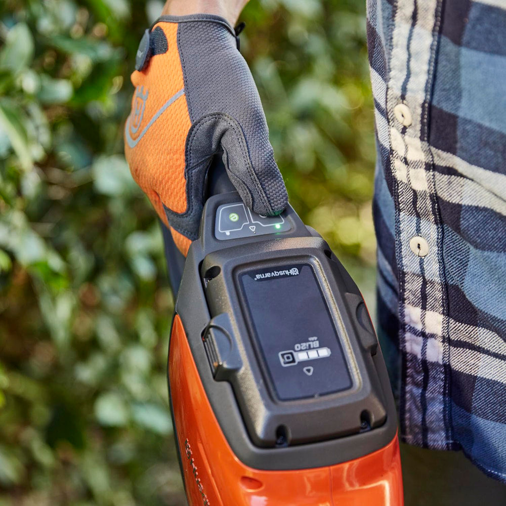 Husqvarna QC80 charger connected to battery providing fast recharge for next trimming session