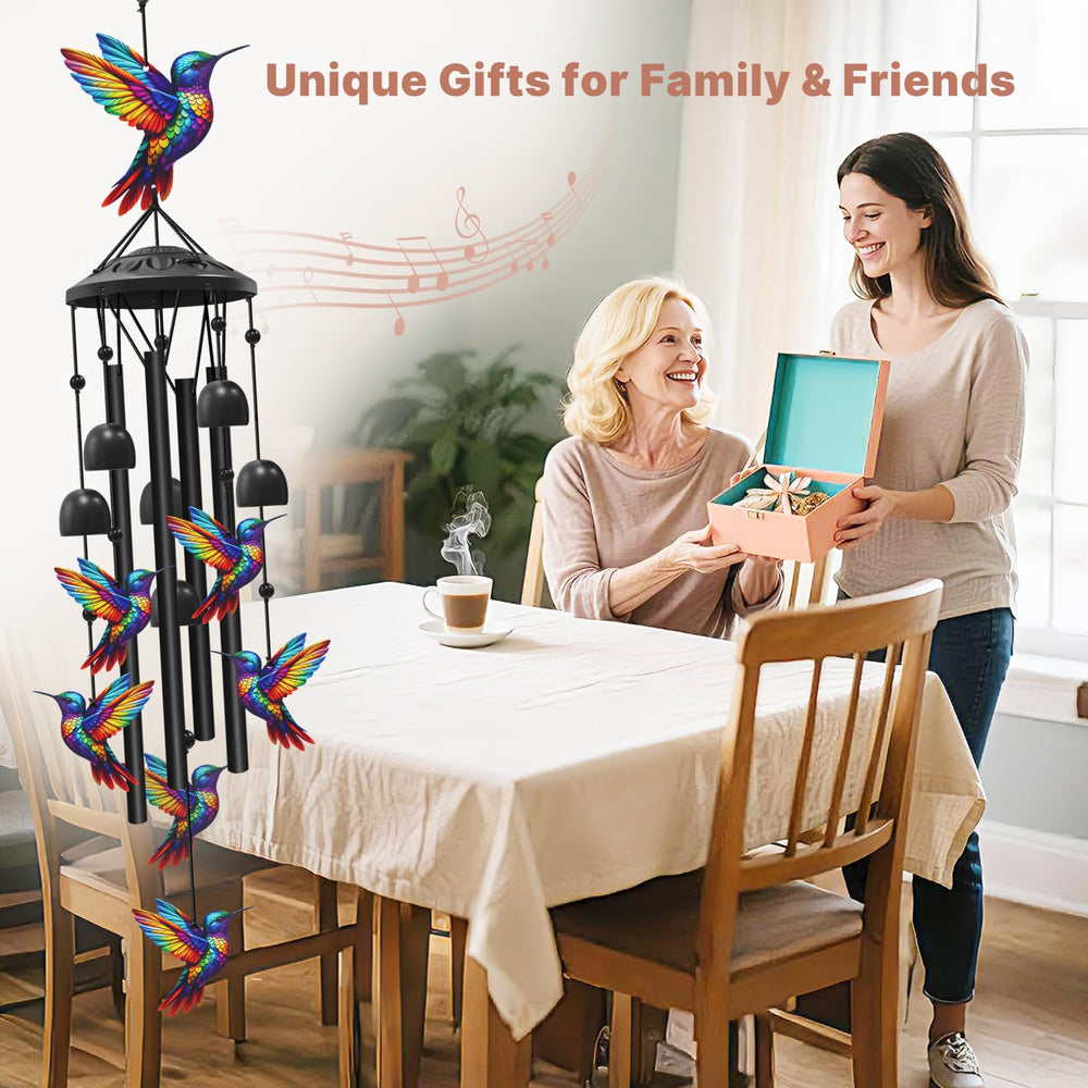 HUVNSOCH chime held in hand demonstrating compact size and lightweight build