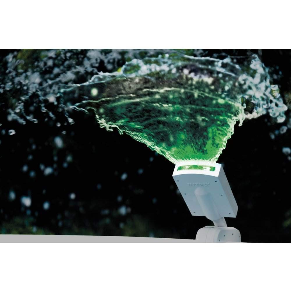 Intex lifestyle scene of evening pool with sprayer adding colorful lighting and atmosphere